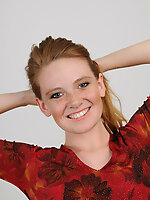 Joyful redhead in sexy panties shows her hairy pussy on the couch