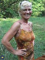 Mature blonde with short hair exposing her ass outdoors