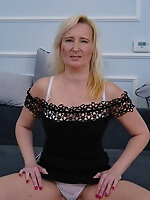 Mature blonde strips naked and thrusts toy into own hairy snatch